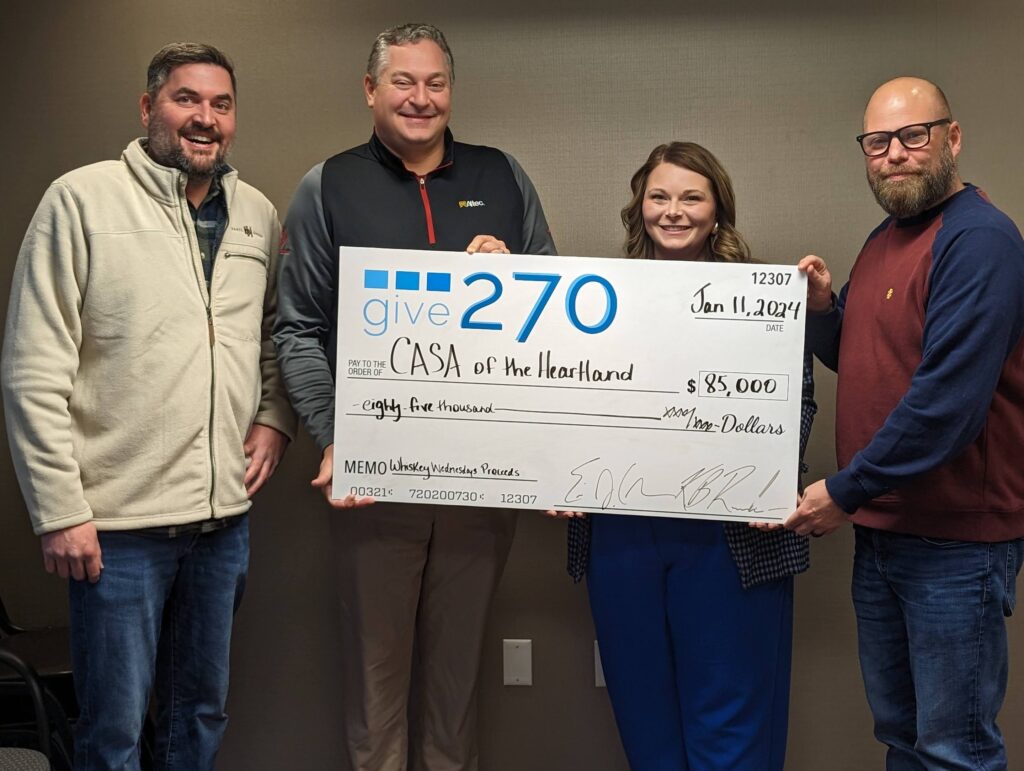 Pictured are CASA of the Heartland Board Chair Grant Niebuhr and Executive Director Michelle Kail (middle), and Give 270 Co-Founders Eric Clemens and Kenny Rambo (far left and right)